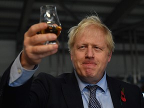 British Prime Minister Boris Johnson tastes whisky during an election campaign visit to Diageo's Roseisle Distillery near Elgin, northeast Scotland, on Nov. 7, 2019.