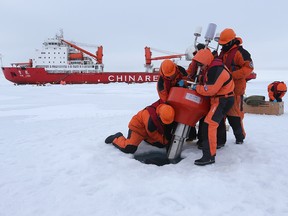 Members of a Chinese research team set up an ocean-profiling float near the icebreaker Xuelong, or "Snow Dragon," in the Arctic Ocean on Aug. 18, 2016.