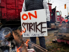 A Teamsters Canada union worker pickets against Canadian National Railway in Brampton, Ont., Nov. 19, 2019.
