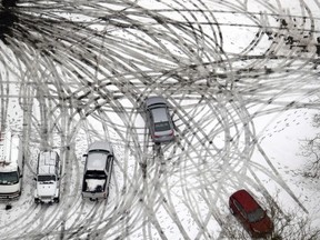 A car maneuvers through a snow-covered parking lot in Seattle on Feb. 11, 2019. For the past several weeks Quebec drivers have been in a race against time to equip their cars for winter or face steep fines. While the majority of Canadian drivers install winter tires for the cold season, according to the Tire and Rubber Association of Canada, Quebec is the only province to force motorists to do so.