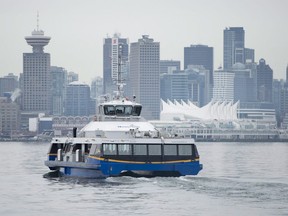 Downtown Vancouver is pictured in the background as a translink Seabus leaves North Vancouver, B.C., Wednesday, Feb. 4, 2015. An overtime ban by Metro Vancouver transit drivers snarled the morning commute for many bus passengers.