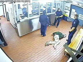 Corey Rogers lies on the floor under police custody at the Halifax police station, wearing a spit hood at about 11 p.m. on June 15, 2016 in this still image taken from surveillance video provided by Nova Scotia Courts.