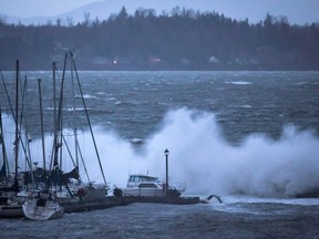 Boats are battered by waves at the end of the White Rock Pier that was severely damaged during a windstorm, in White Rock, B.C., on Thursday December 20, 2018. British Columbia's Crown utility says residents are largely unprepared for power outages despite increasingly severe winter storms.