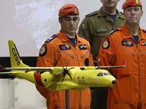 Cpl. Chris Auger and Warrent Officer Aaron Bygrove looks at a model of the Airbus C295 at CFB Trenton in Trenton, Ontario, on Thursday Dec. 8, 2016. The Canadian Armed Forces is refusing to accept the first of its new search-and-rescue planes from European manufacturer Airbus because of concerns with the aircraft's manuals. THE CANADIA PRESS/Lars Hagberg