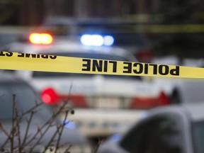 Police attend to a crime scene in Calgary, Thursday, Jan. 1, 2015.THE CANADIAN PRESS/Jeff McIntosh