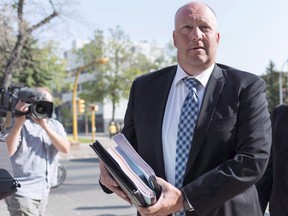 Regina's police chief says a policy shift is coming that will see more officers carrying the life-saving antiode nalxone. Regina Police Services chief Evan Bray, left arrives to the Court of Queen's Bench in Regina on Thursday August 23, 2018.
