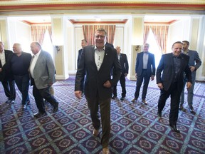 Saskatchewan Premier Scott Moe, centre, along with fellow Premiers break away following a group photo during a meeting of Canada's Premiers in Saskatoon, Sask. Thursday, July 11, 2019. Saskatchewan Premier Scott Moe says an upcoming sit down of Canada's premiers will be an important chance to send a message to a prime minister that's dealing with regional divisions.