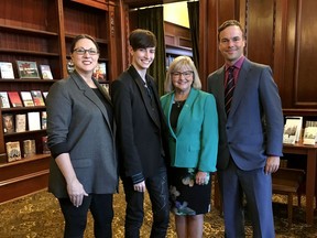 Members of British Columbia's legislature marked Canada's Transgender Day of Remembrance by viewing a documentary that follows a depressed, suicidal female teenager's three-year surgical and life-changing transition to a beaming male supermodel on the fashion runways of Paris. Canada's first trans supermodel Krow, second from left, poses for a photo with filmmaker Gina Hole Lazarowich, left to right, Liberal MLA Jane Thornthwaite and NDP MLA Spencer Chandra Herbert inside the provincial legislature library, in Victoria, Wednesday, Nov. 20, 2019.