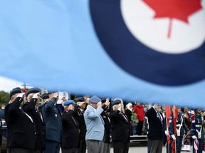 The Royal Canadian Air Force flag flies as veterans salute during a ceremony marking the 79th anniversary of the Battle of Britain in Ottawa on Sunday, Sept. 15, 2019. judge has certified a class-action lawsuit from former military reservists who say they endured lengthy waits for pension payments.