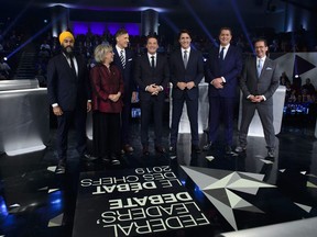 Host Patrice Roy from Radio-Canada, centre, introduces Federal party leaders, left to right, NDP leader Jagmeet Singh, Green Party leader Elizabeth May, People's Party of Canada leader Maxime Bernier, Liberal leader Justin Trudeau, Conservative leader Andrew Scheer, and Bloc Quebecois leader Yves-Francois Blanchet before the Federal leaders French language debate in Gatineau, Que. on October 10, 2019.