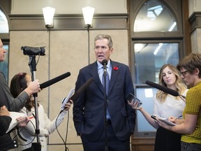 The Manitoba government is taking out newspaper and electronic advertisements in Quebec that welcome civil servants to move to Manitoba if they feel threatened by Quebec's ban on religious symbols in the workplace. Manitoba Premier Brian Pallister speaks to reporters after meeting with Prime Minister Justin Trudeau, not shown, on Parliament Hill in Ottawa, Friday, Nov. 8, 2019.