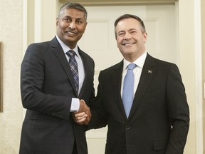 Alberta premier Jason Kenney shackles hands with Prasad Panda, Minister of Infrastructure after being sworn into office, in Edmonton on Tuesday April 30, 2019. Alberta is back in the business of partnering with the private sector to build schools. Infrastructure Minister Prasad Panda says five of 25 new school projects getting built over the next five years may be constructed using the so-called P3 method.