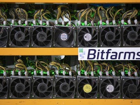 Miners are seen at the Bitfarms bitcoin mine in Magog, Que., on May 8, 2019. Bitfarms marketed itself last spring as a socially conscious company, harnessing unused, sustainable hydroelectricity to help power Quebec's digital economy while also providing much-needed revenue for the province's struggling regions. But since that time, the cryptocurrency mining firm has run into difficulties.
