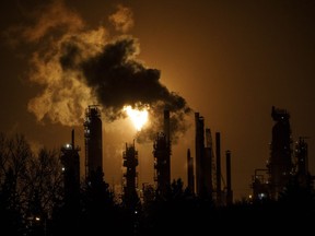 A flare stack lights the sky from the Imperial Oil refinery in Edmonton Alta, on Friday December 28, 2018. Canada's promise to produce an inventory of its fossil fuel subsidies as part of a joint peer review with Argentina appears to be off schedule and may not deliver results until 2021, an environment advocate says.