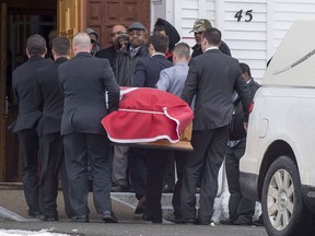 The flag-draped coffin of Lionel Desmond is carried into St. Peter's Church in Tracadie, N.S. on Wednesday, Jan. 11, 2017. It was almost three years ago that Desmond - a deeply disturbed Afghan war veteran diagnosed with PTSD - killed his mother, wife and young daughter before taking his own life in the family's rural Nova Scotia home.THE CANADIAN PRESS/Andrew Vaughan