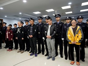 People charged with smuggling fentanyl to the U.S. are seen during a court sentencing in Xingtai, Hebei province, China November 7, 2019 in this handout picture provided by China National Narcotics Control Commission.