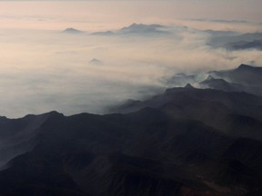 Smoke from bushfires blanket mountain ranges as seen during a commercial flight over northern New South Wales, Australia, November 16, 2019. Picture taken November 16, 2019.