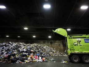 A GFL Environmental Inc. garbage truck drops off a load of waste at a transfer station in Toronto. GFL, North America's fourth-largest waste hauler by revenue.