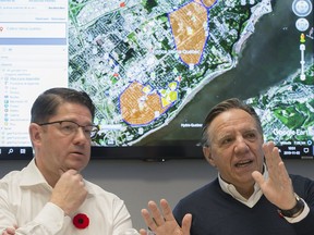Quebec Premier Francois Legault, right, and Hydro Quebec President and CEO Eric Martel update news media on the ongoing power outages in the province during a briefing in Montreal, Saturday, November 2, 2019.