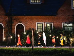 A group of children go trick or treating for Halloween.