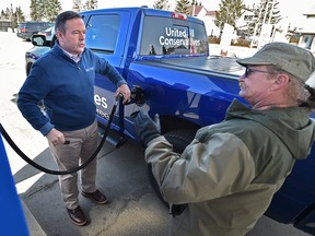 Alberta United Conservative Leader Jason Kenney discusses his opposition to the federal carbon tax while filling up his truck during a news conference in West Edmonton on April 1, 2019.