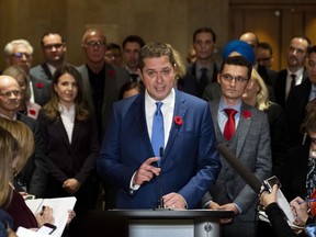 Conservative leader Andrew Scheer is surrounded by members of his caucus as he speaks to reporters following a caucus meeting on Parliament Hill in Ottawa, on Wednesday, Nov. 6, 2019.