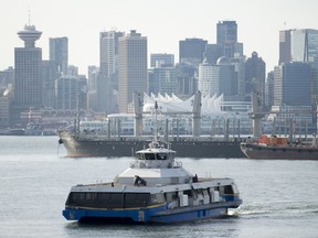 A seabus is pictured as it crosses Vancouver harbour with downtown Vancouver pictured in the background Wednesday, October, 30, 2019. TransLink says more SeaBus sailings will be cancelled today as the transit workers' job action enters its third day.