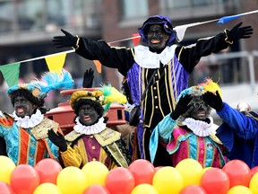 Assistants of Saint Nicholas called "Zwarte Piet" (Black Pete) arrive by boat at the harbour of Scheveningen, Netherlands, November 16, 2019.