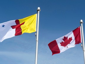 The Nunavut flag and the Canadian flag are seen Saturday, April 25, 2015 in Iqaluit, Nunavut. Major government departments in Nunavut are at least still partly impacted after a weekend cyber attack.