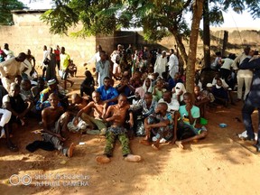 People sit on the ground after being freed by police from an Islamic rehabilitation centre in Ibadan, Nigeria in this picture released by Nigeria Police November 5, 2019.