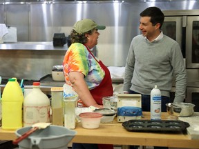 Democratic presidential candidate Pete Buttigieg speaks with Ellen Skonberg during a campaign stop at Polly's Pancake Parlor on November 10, 2019 in Franconia, New Hampshire.