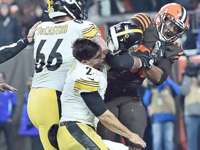 Cleveland Browns defensive end Myles Garrett (95) hits Pittsburgh Steelers quarterback Mason Rudolph (2) with his own helmet as offensive guard David DeCastro (66) tries to stop Garrett during the fourth quarter at FirstEnergy Stadium.