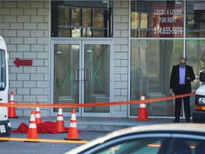 Investigators stand near the body of alleged mob boss Andrew Scoppa, who was shot to death, in Montreal, Monday, Oct. 21, 2019.