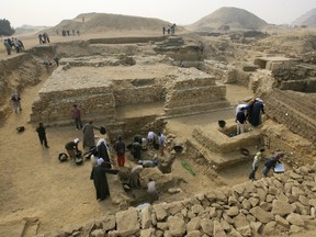 Egyptian archaeologists work at an ancient burial ground in Saqqara which dates back to 2,700 BC, about 35 kms south of Cairo, on November 11, 2008.