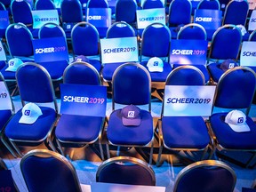 Signs and hats sit on chairs ahead of a Conservative party election night event in Regina on Oct. 21, 2019.