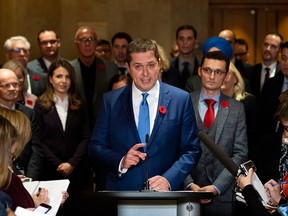 Conservative Leader Andrew Scheer is surrounded by members of his caucus as he speaks to reporters following a caucus meeting on Parliament Hill on Nov. 6, 2019.