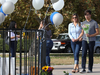 A Saugus High School student brings flowers to a makeshift memorial to victims of the shooting at the school on Nov. 15, 2019 in Santa Clarita, California.