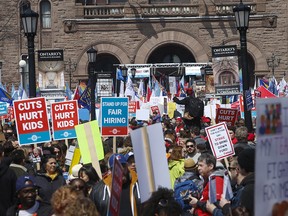 Thousands of teachers, students and unionists  protest funding cuts to Ontario's education system on the front lawn of the provincial legislature on April 6, 2019.