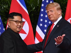 U.S. President Donald Trump, right, meets with North Korea's leader Kim Jong Un at the start of their U.S.-North Korea summit, at  in Singapore in 2018.