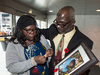 May Hyacenth Abudu and Abudu Ibn Adam hold a photo of their five-year-old daughter Amina, who died days after receiving the pandemic-flu vaccine in 2009.