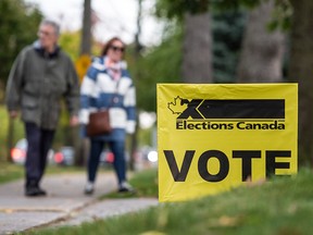 People arrive at Clarkson Presbyterian Church in Mississauga, Ont., to vote in the 2019 federal election, on Oct. 21, 2019.