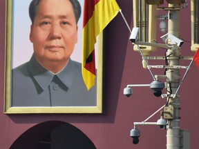 Surveillance cameras and the portrait of late communist leader Mao Zedong are spotted in Tiananmen Square in Beijing on Sept. 6, 2019.