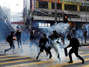 Anti-government protesters react as police fire tear gas during a protest in Hong Kong, China November 2, 2019.