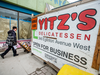 A Yitz’s employee hauls food past LRT construction into the soon to be closed deli. “It’s like we’re in jail,” manager, Claudio Araujo said.