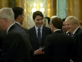 This grab made from a video shows Dutch Prime Minister Mark Rutte (L), French President Emmanuel Macron (front),  British Prime Minister Boris Johnson (R) and Canada's Prime Minister Justin Trudeau (back-C) as the leaders of Britain, Canada, France and the Netherlands were caught on camera at a Buckingham Palace reception mocking U.S. President Donald Trump's lengthy media appearances ahead of the NATO summit on December 3, 2019 in London.