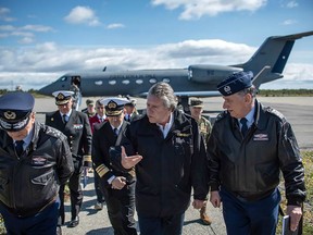 Handout picture released by the Chilean Defence Minsitry showing Chile's Defence Minister Alberto Espina (C) arriving at Chabunco army base in Punta Arenas, Chile, on December 10, after a Chilean Air Force C-130 Hercules cargo plane went missing in the sea between the southern tip of South America and Antarctica.