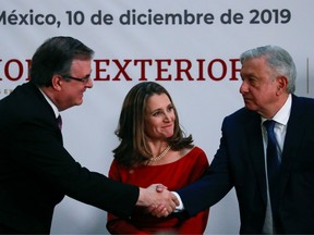 Canadian Deputy Prime Minister Chrystia Freeland looks on while Mexico's President Andres Manuel Lopez Obrador shakes hands with Mexico's Foreign Minister Marcelo Ebrard, during a meeting at the Presidential Palace, in Mexico City, Mexico December 10, 2019.