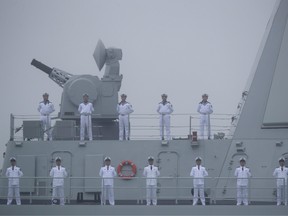 Sailors stand on the deck of the new type 055 guide missile destroyer Nanchang of the Chinese People's Liberation Army (PLA) Navy as it participates in a naval parade to commemorate the 70th anniversary of the founding of China's PLA Navy in the sea near Qingdao, in eastern China's Shandong province on April 23, 2019.