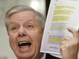 Senate Judiciary Committee Chairman Lindsey Graham (R-SC) holds up a copy of the Steel dossier as Michael Horowitz, inspector general for the Justice Department, testifies before the Senate Judiciary Committee in the Hart Senate Office Building on December 11, 2019 in Washington, DC.