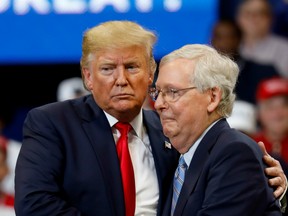 Senator Mitch McConnell (R-KY) hugs U.S. President Donald Trump at a Keep America Great Rally at the Rupp Arena in Lexington, Kentucky, U.S., November 4, 2019.